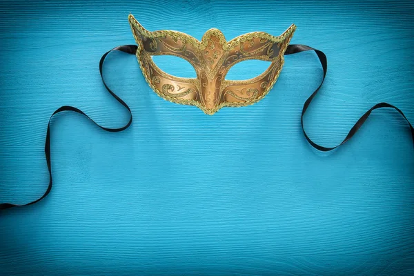 Image of elegant venetian mask over colorful background.