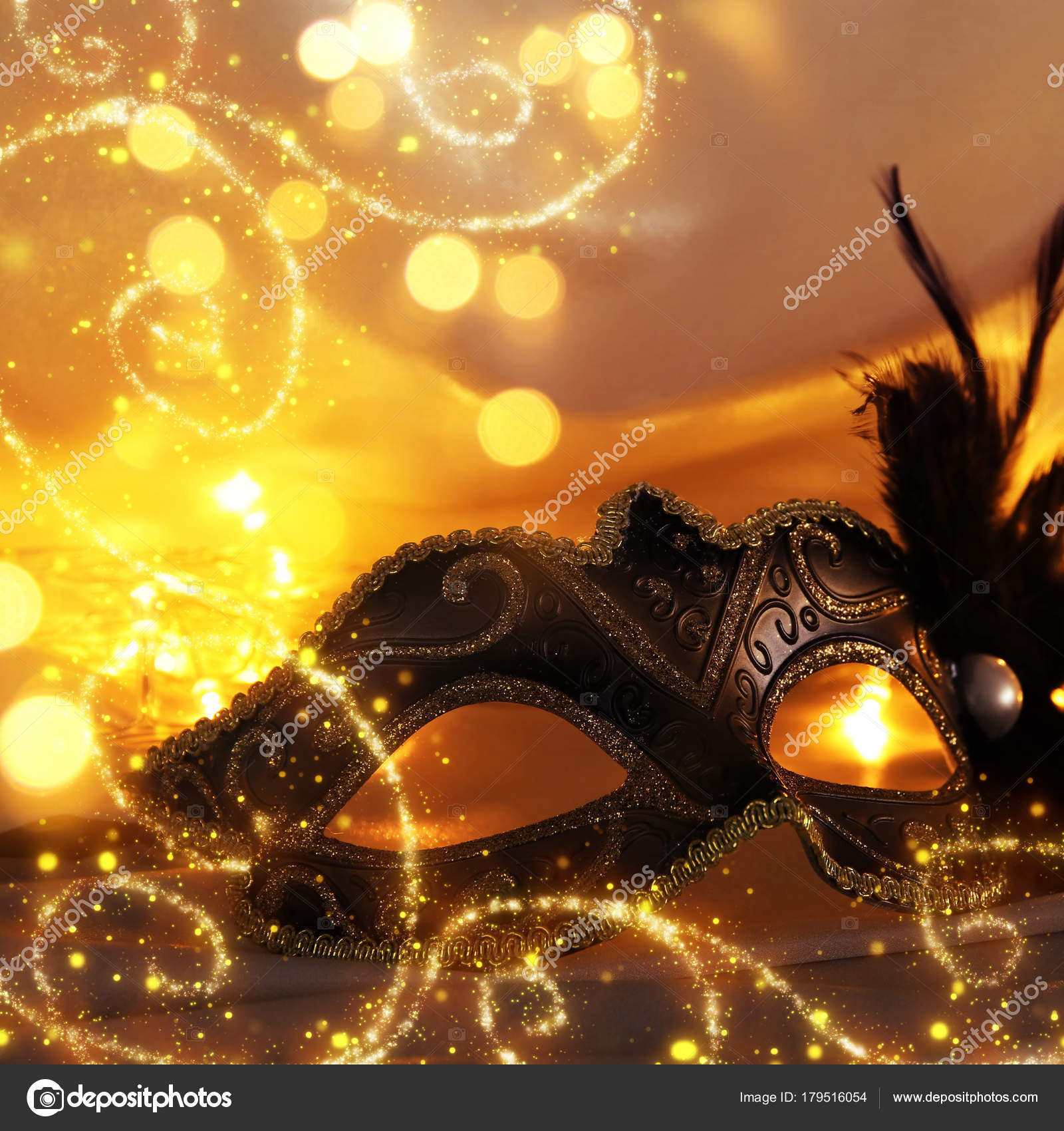 Image of elegant venetian mask over gold silk background. Stock Photo