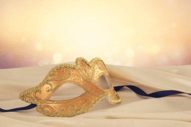 Zarif altın Venedik Maske üzerinde hassas ipek kumaş arka plan görüntü.