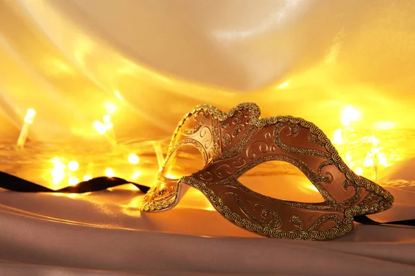 Image of elegant venetian mask over gold silk background. — Stock Photo, Image