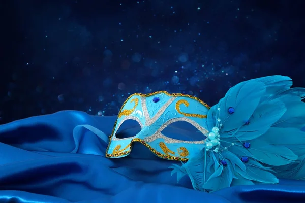 Image of elegant blue and gold venetian mask over blue silk fabric background — Stock Photo, Image