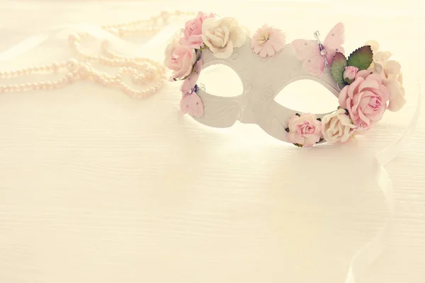 Image of delicate elegant venetian mask over wooden white background. Selective focus. — Stock Photo, Image