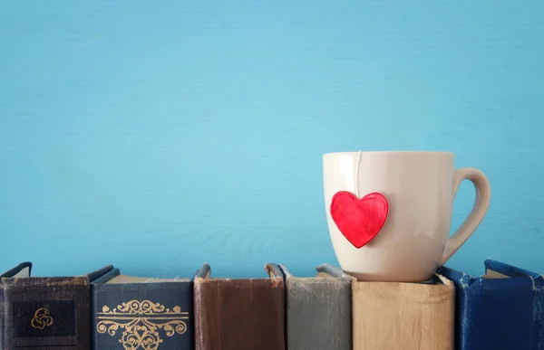 Valentine's day background. Cup of coffee or tea or coffee over old books. — Stock Photo, Image