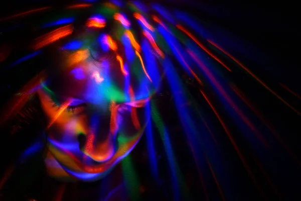 Abstract portrait of young girl under colorful fluorescent Neon dark lights, enigmatic style. — Stock Photo, Image