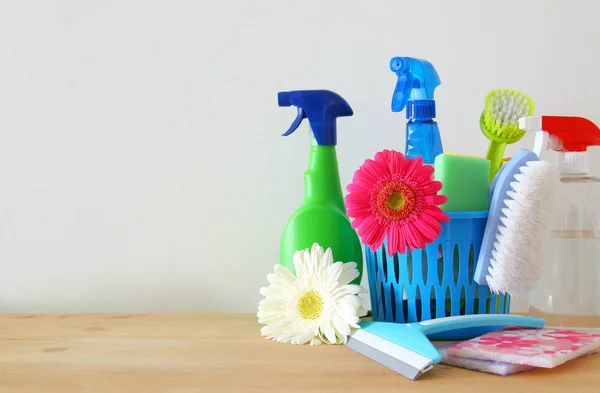 Spring cleaning concept with supplies on wooden table. — Stock Photo, Image