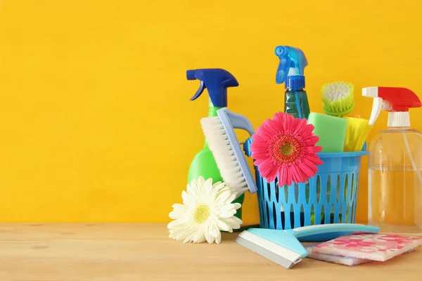 Spring cleaning concept with supplies on wooden table. — Stock Photo, Image