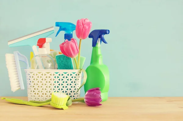 Spring cleaning concept with supplies on wooden table. — Stock Photo, Image