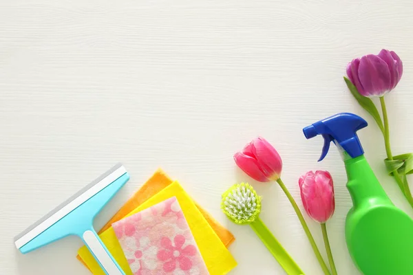 Spring cleaning concept with supplies on wooden table. — Stock Photo, Image