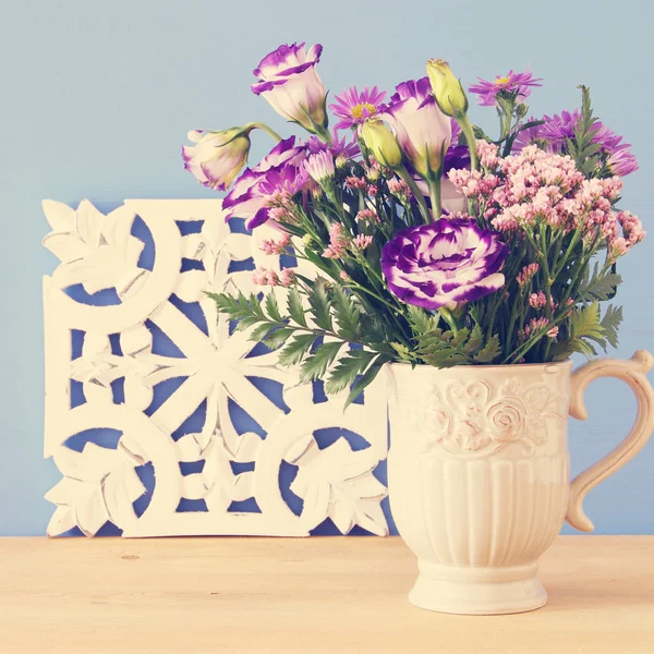 Buquê de verão de flores roxas no vaso sobre mesa de madeira e fundo azul . — Fotografia de Stock