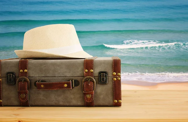 Reiziger vintage bagage en fedora hoed over houten tafel. holid — Stockfoto
