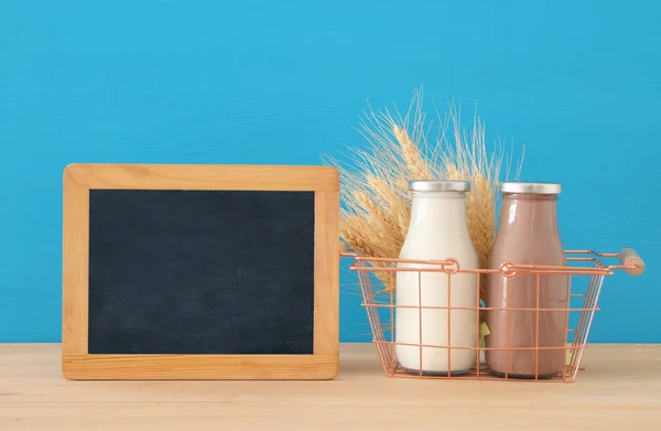 Image of milk and chocolate over wooden table. Symbols of jewish holiday - Shavuot. — Stock Photo, Image