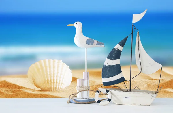 Nautical concept with white decorative seagull bird and boat over tropical sea landscape background. — Stock Photo, Image