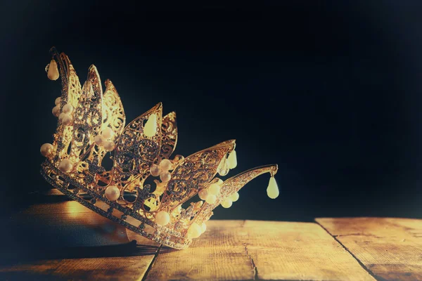 Low key image of beautiful queen/king crown on old book. fantasy medieval period. Selective focus. — Stock Photo, Image