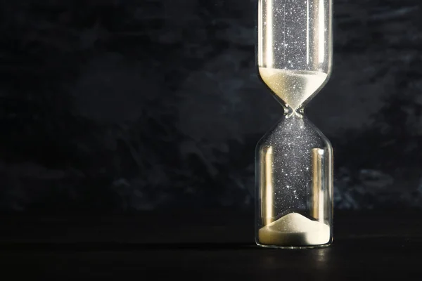 Image of hourglass as time passing concept over black background for business deadline. Glitter overlay. — Stock Photo, Image
