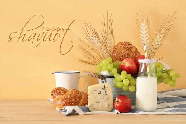 Image of fruits, bread and cheese in the tin basket over wooden table. — Stock Photo, Image