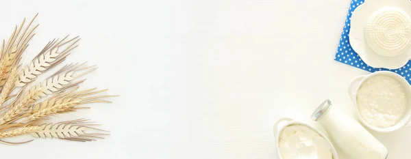 Top view image of dairy products over white wooden background. Symbols of jewish holiday - Shavuot. — Stock Photo, Image