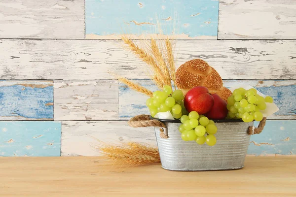 Image of fruits in the tin basket over wooden table. — Stock Photo, Image
