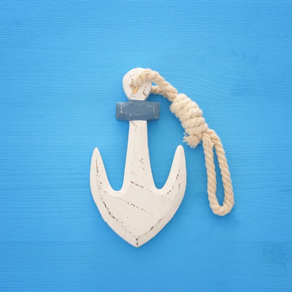 Vacation and summer image with anchor over blue wooden background. — Stock Photo, Image