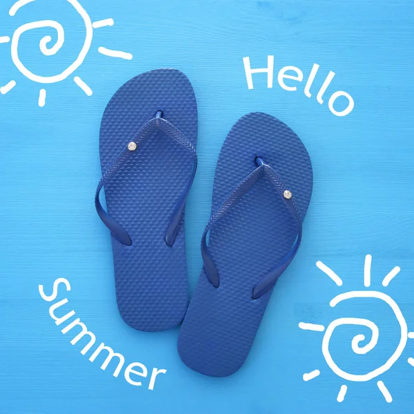 Vacation and summer image with flipflops over blue wooden background. — Stock Photo, Image