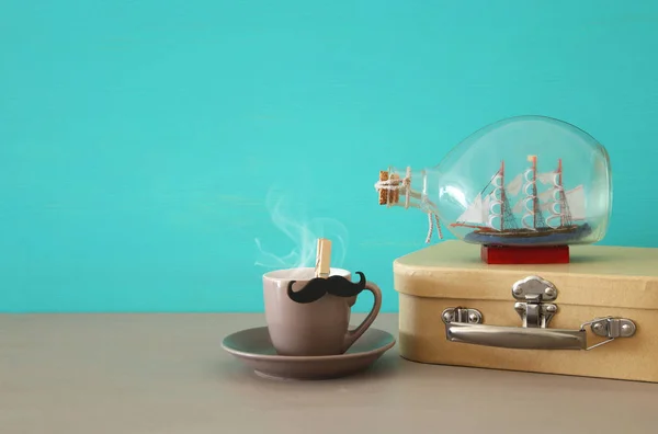 Imagen de taza de café, caja vieja y barco en la botella sobre mesa de madera. Concepto del día del padre . — Foto de Stock