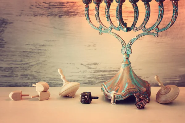 Religion image of jewish holiday Hanukkah background with menorah (traditional candelabra) and dreidels — Stock Photo, Image