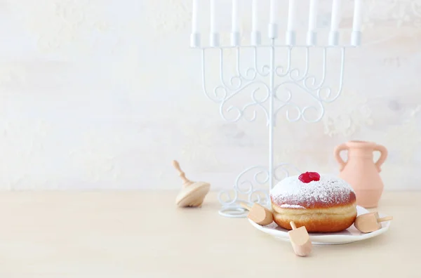 Imagen religiosa de vacaciones judías fondo Hanukkah con menorah (candelabro tradicional), peonza y rosquilla sobre fondo blanco —  Fotos de Stock