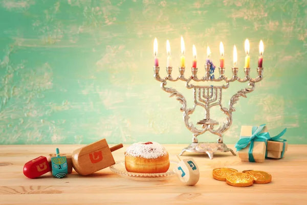 Religion image of jewish holiday Hanukkah background with menorah (traditional candelabra), spinning top and doughnut — Stock Photo, Image