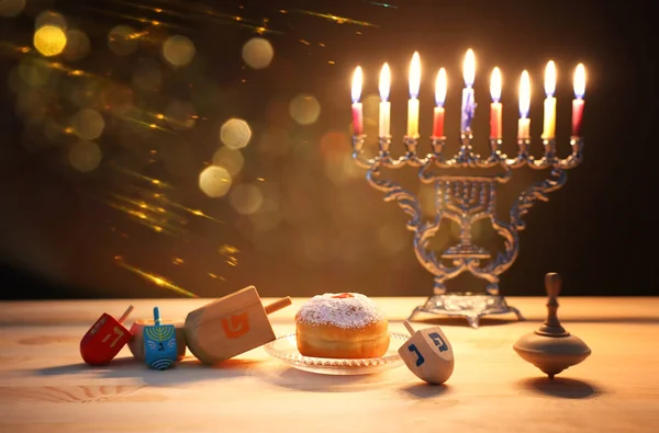 Religion image of jewish holiday Hanukkah background with menorah (traditional candelabra), spinning top and doughnut — Stock Photo, Image