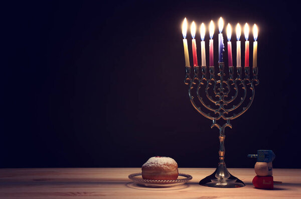 religion image of jewish holiday Hanukkah background with menorah (traditional candelabra), spinning top and doughnut