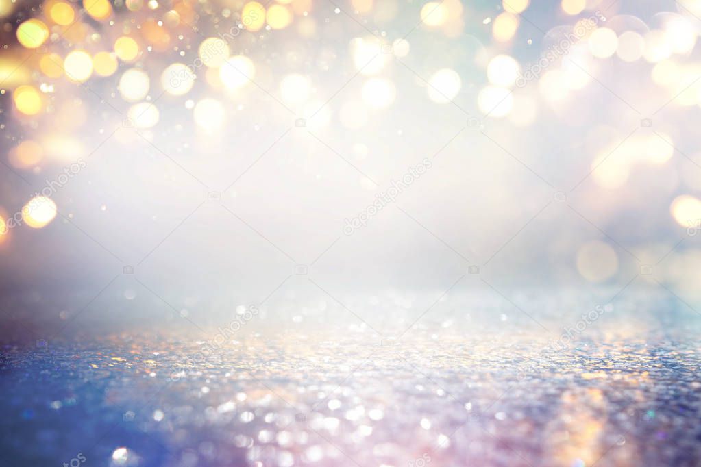 abstract glitter silver, gold and blue lights background. de-focused