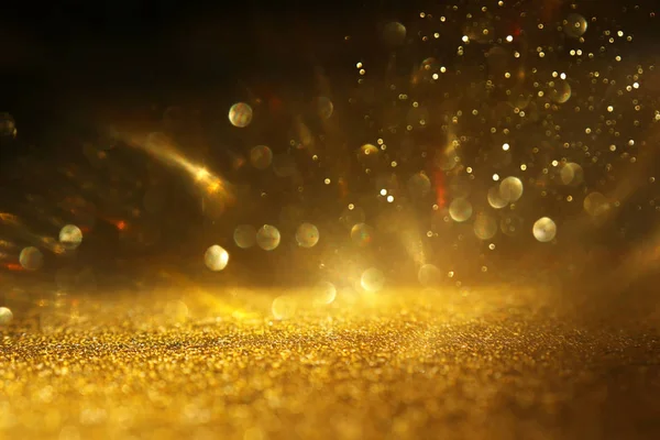 Sfondo di luci glitter astratte. oro e nero. de focalizzata — Foto Stock