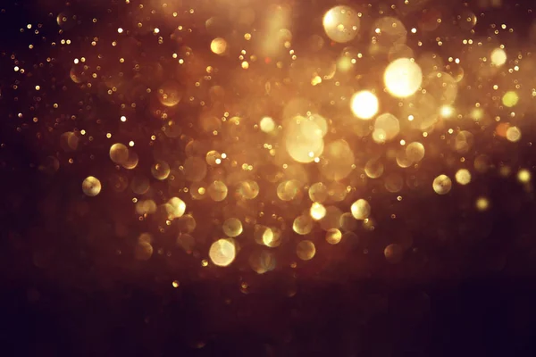 Achtergrond van abstracte glitter lichten. goud en zwart. de focus — Stockfoto