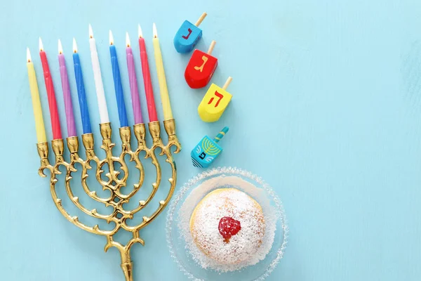 Religion image of jewish holiday Hanukkah background with menorah (traditional candelabra), spinning top and doughnut — Stock Photo, Image