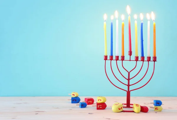 Religion image of jewish holiday Hanukkah background with menorah (traditional candelabra) and spinning top — Stock Photo, Image