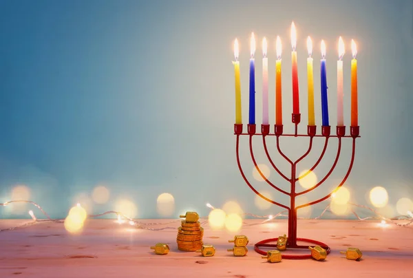 Religion image of jewish holiday Hanukkah background with menorah (traditional candelabra) and spinning top — Stock Photo, Image