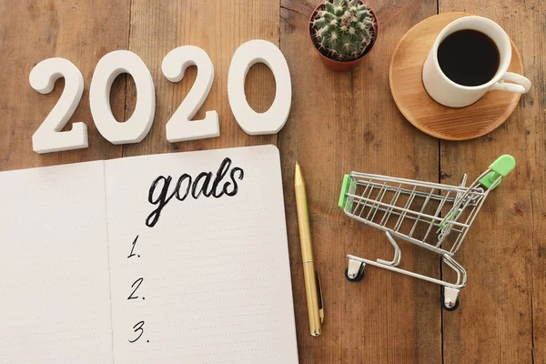 Conceito de negócio de vista superior 2020 lista de metas com notebook, xícara de café sobre mesa de madeira — Fotografia de Stock