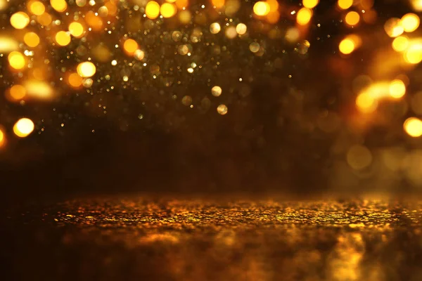 Achtergrond van abstracte glitter lichten. goud en zwart. de focus — Stockfoto