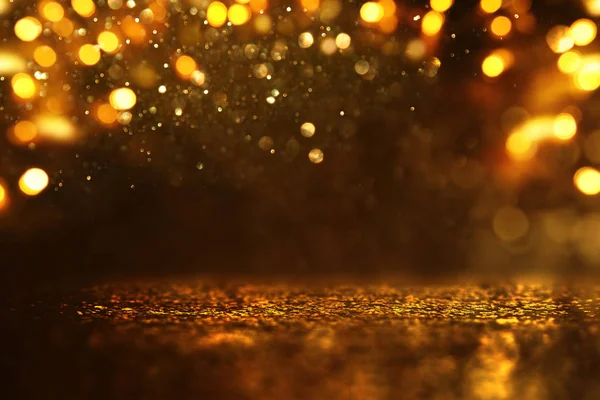 Background of abstract glitter lights. gold and black. de focused — Stock Photo, Image