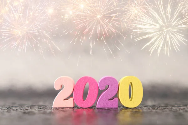 Holiday image of New Year 2020 concept. Wooden number and sparkling background