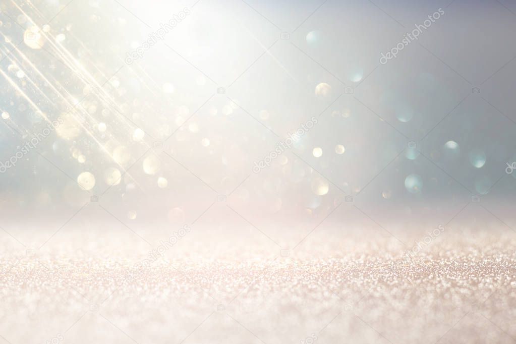 abstract background of glitter vintage lights . silver, gold and white. de-focused