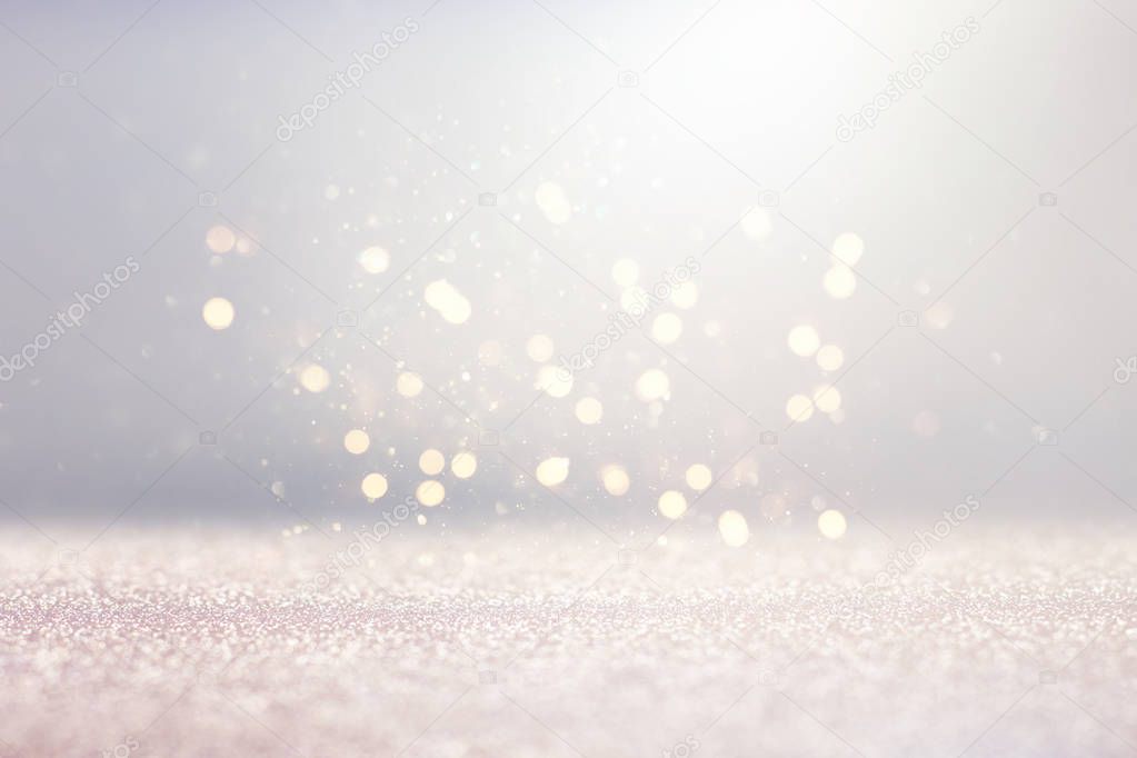 abstract background of glitter vintage lights . silver, gold and white. de-focused