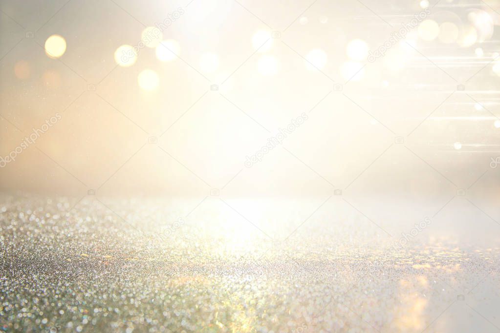 abstract background of glitter vintage lights . silver, gold and white. de-focused