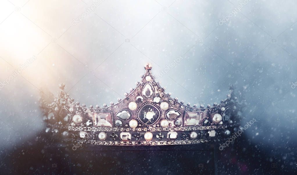 mysterious and magical photo of of beautiful queen/king crown over gothic snowy dark background. Medieval period concept