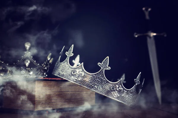 Low key image of beautiful queen/king crown over antique book ne — Stock Photo, Image