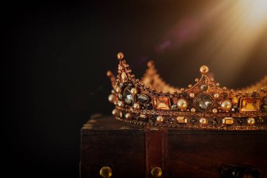 Tahta masanın üzerindeki güzel kraliçe ve kral tacının gösterişsiz görüntüsü. v