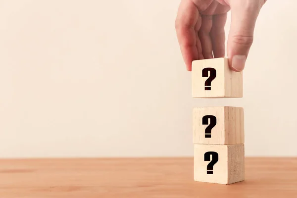 Background of a stack of wooden blocks with a question mark symbol on a table — Stock Photo, Image