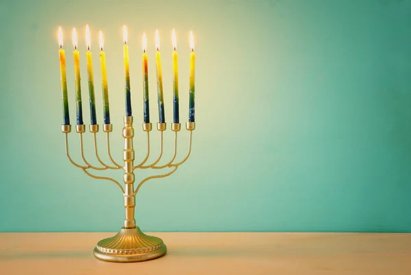 Religion image of jewish holiday Hanukkah background with brass menorah (traditional candelabra) and candles — Stock Photo, Image