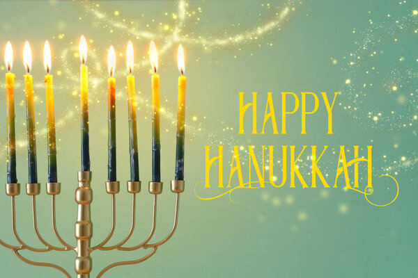 Religion image of jewish holiday Hanukkah background with brass menorah (traditional candelabra) and candles