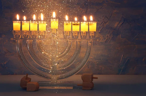 Image of jewish holiday Hanukkah background with crystal menorah (traditional candelabra) and colorful oil candles — Stock Photo, Image