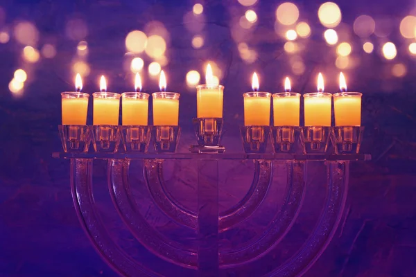 Image of jewish holiday Hanukkah background with crystal menorah (traditional candelabra) and colorful oil candles — Stock Photo, Image